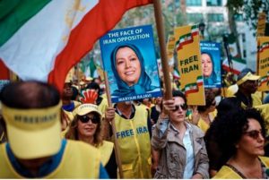 Protesters carry placards and wave flags outside the United Nations headquarters in New York on Wednesday, Sept. 20, 2017. The rally, organized by the Organization of Iranian American Communities, highlighted human rights abuses and called for democratic change in Iran. (AP Photo/Andres Kudacki)